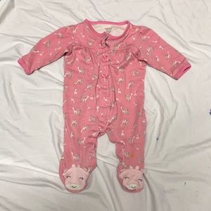 Pink infant onesie with giraffes printed on it